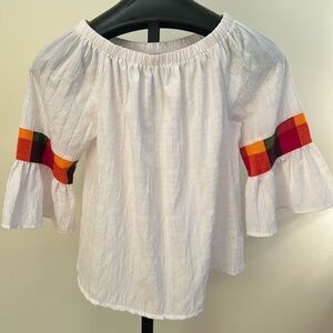 Vanessa’s white blouse with color Block details.